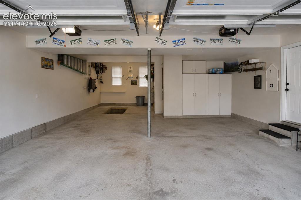 Image 37 of 50: AI render of interior garage without cars (Note: There is a mechanic/oil pi