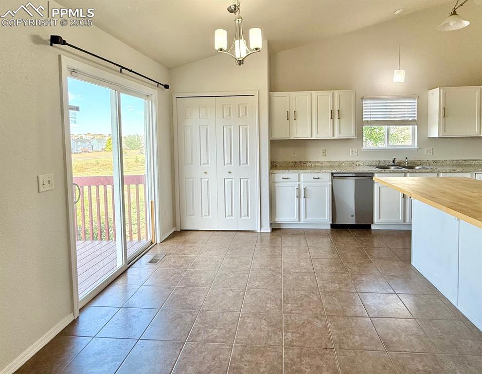 Image 11 of 37: Dining space with lofted ceiling