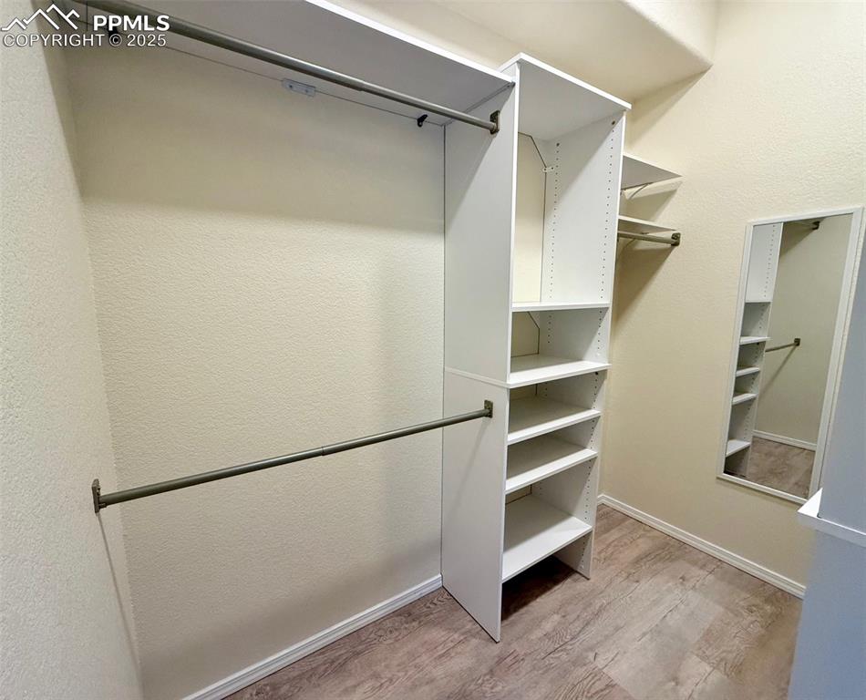 Image 14 of 37: Spacious closet with light wood-style floors