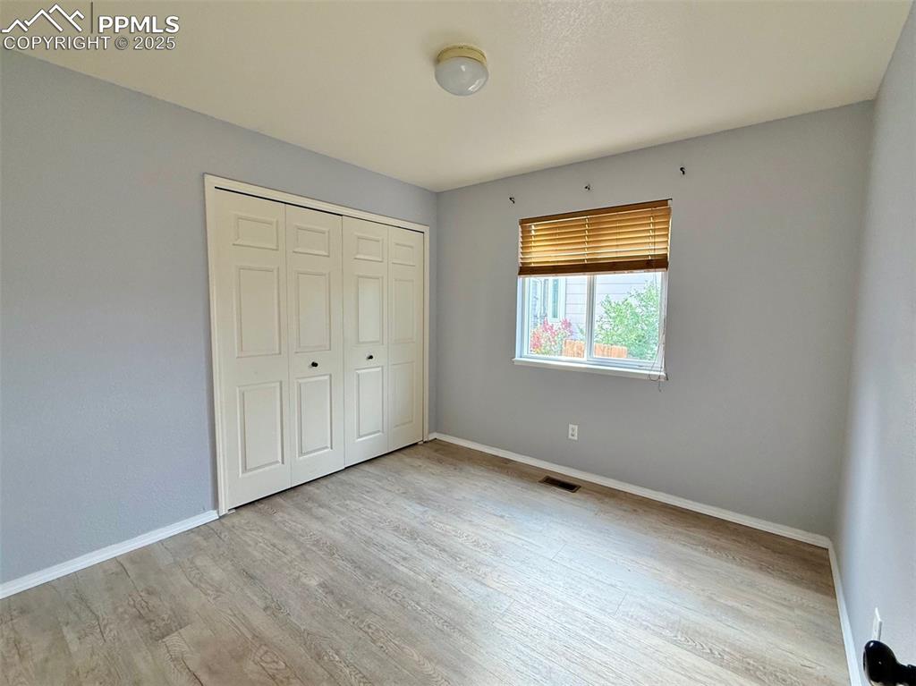 Image 18 of 37: Unfurnished bedroom featuring light wood-style floors and a closet
