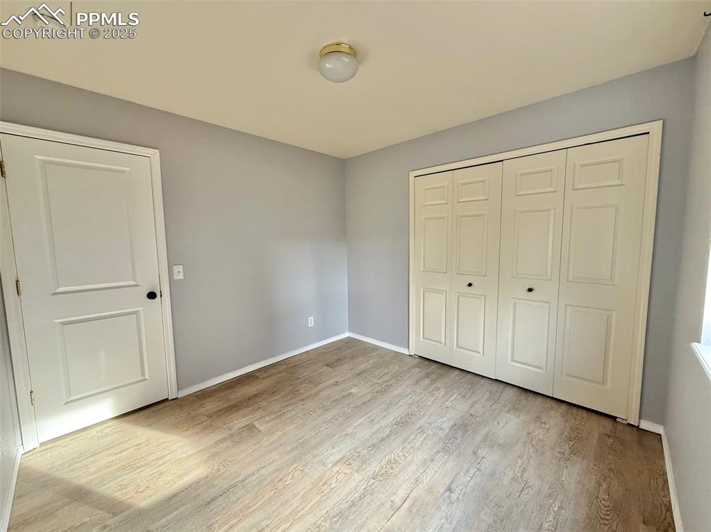 Image 19 of 37: Unfurnished bedroom featuring light wood-style floors and a closet