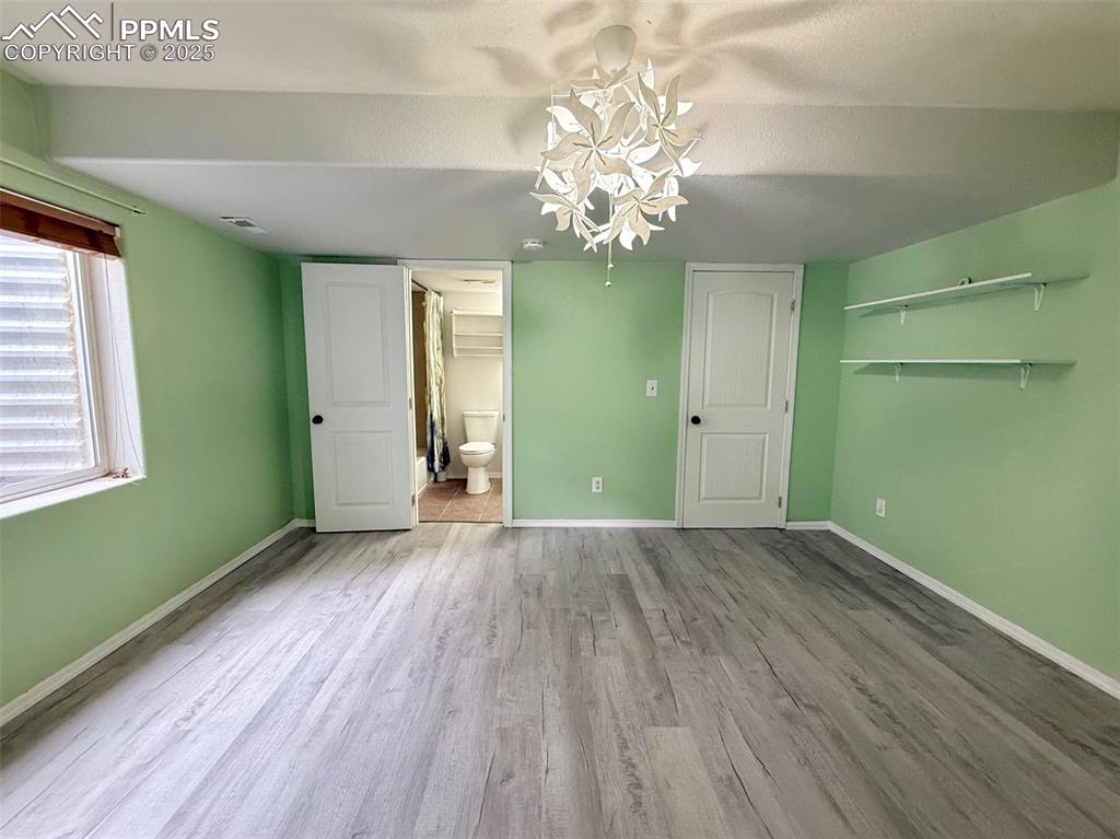 Image 31 of 37: Bedroom with attached bath