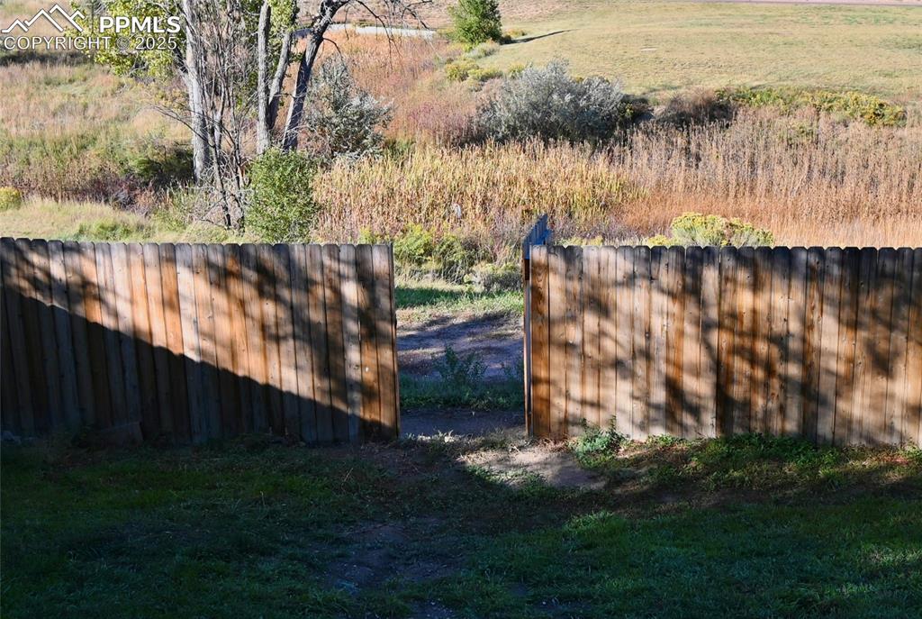 Image 37 of 37: Trail access gate in backyard