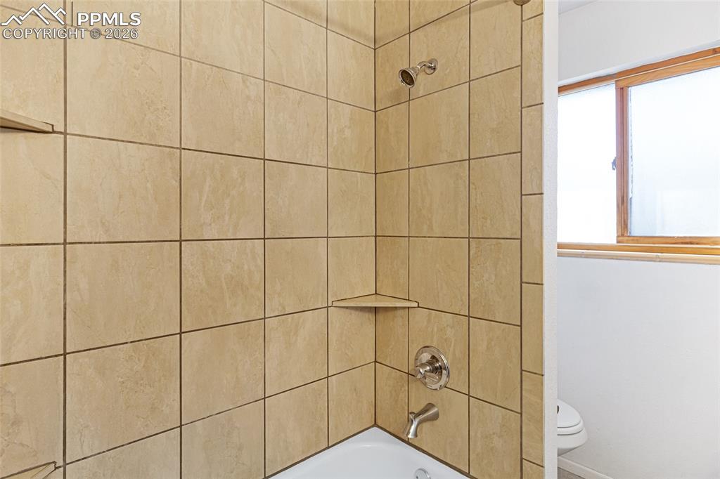 Image 16 of 19: Full bath featuring toilet and shower / bath combination