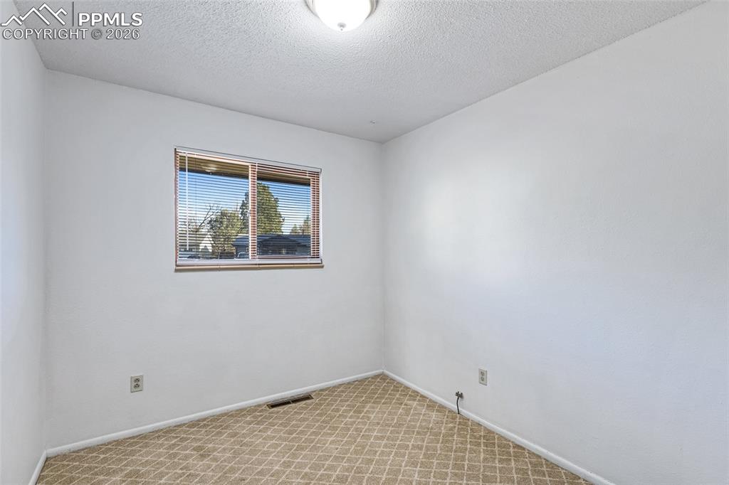 Image 19 of 19: Spare room with light colored carpet and a textured ceiling