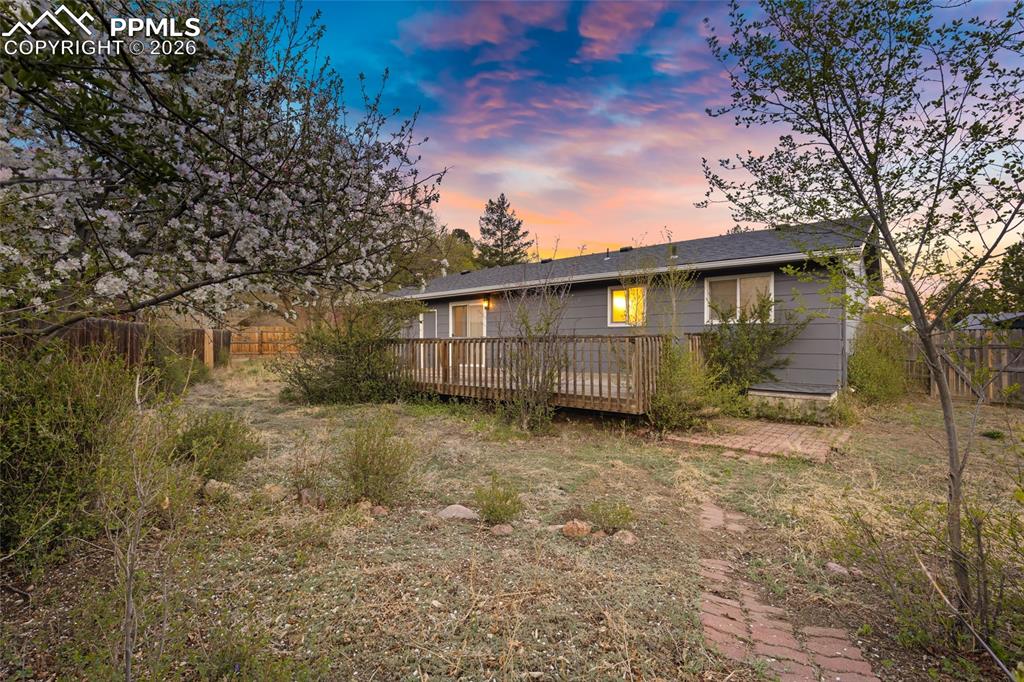 Image 4 of 19: Back of house with a fenced backyard and a deck