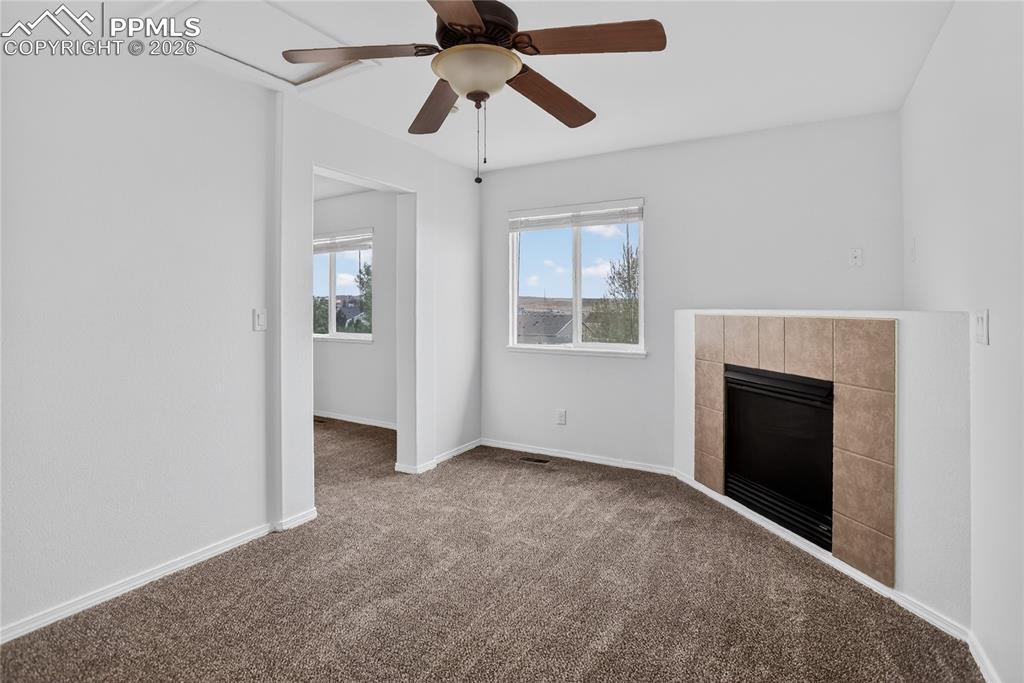 Image 11 of 24: Lofted sitting area off primary suite w/ fireplace