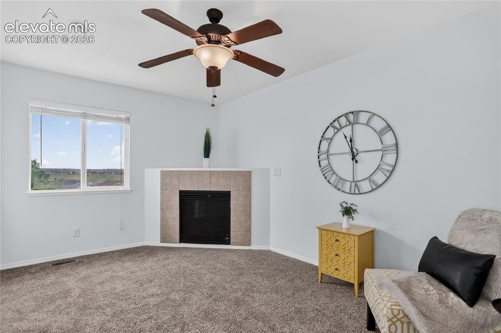 Image 11 of 24: Lofted sitting area off primary suite w/ fireplace