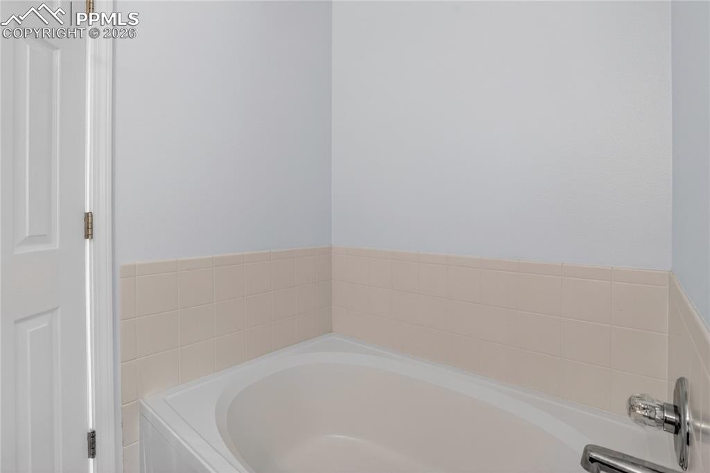 Image 13 of 24: Garden soaking tub in primary bath