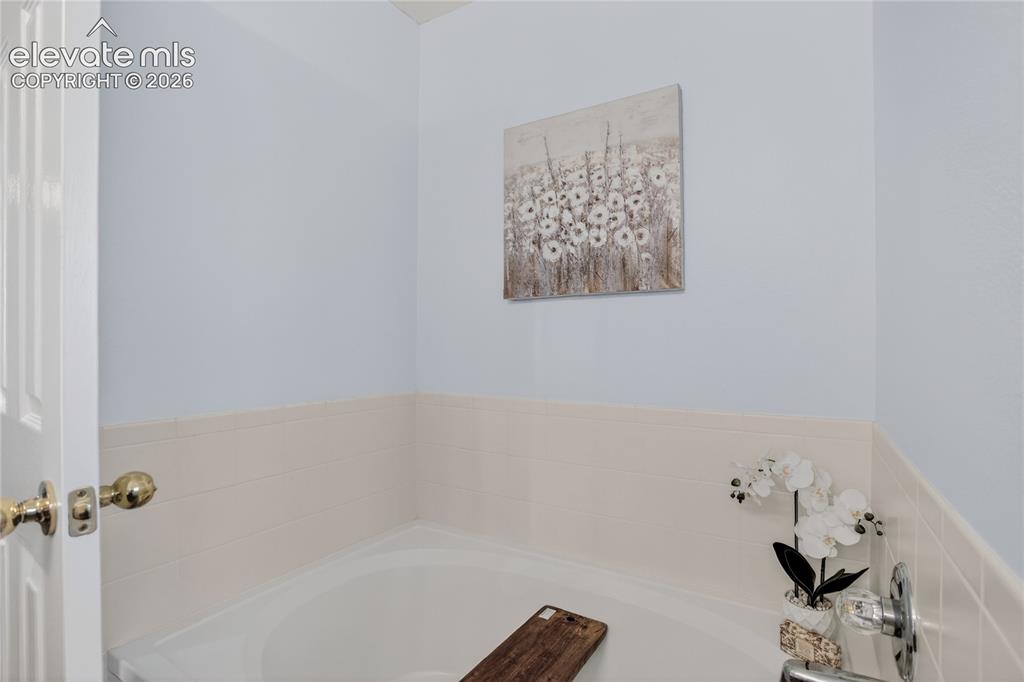 Image 13 of 24: Garden soaking tub in primary bath