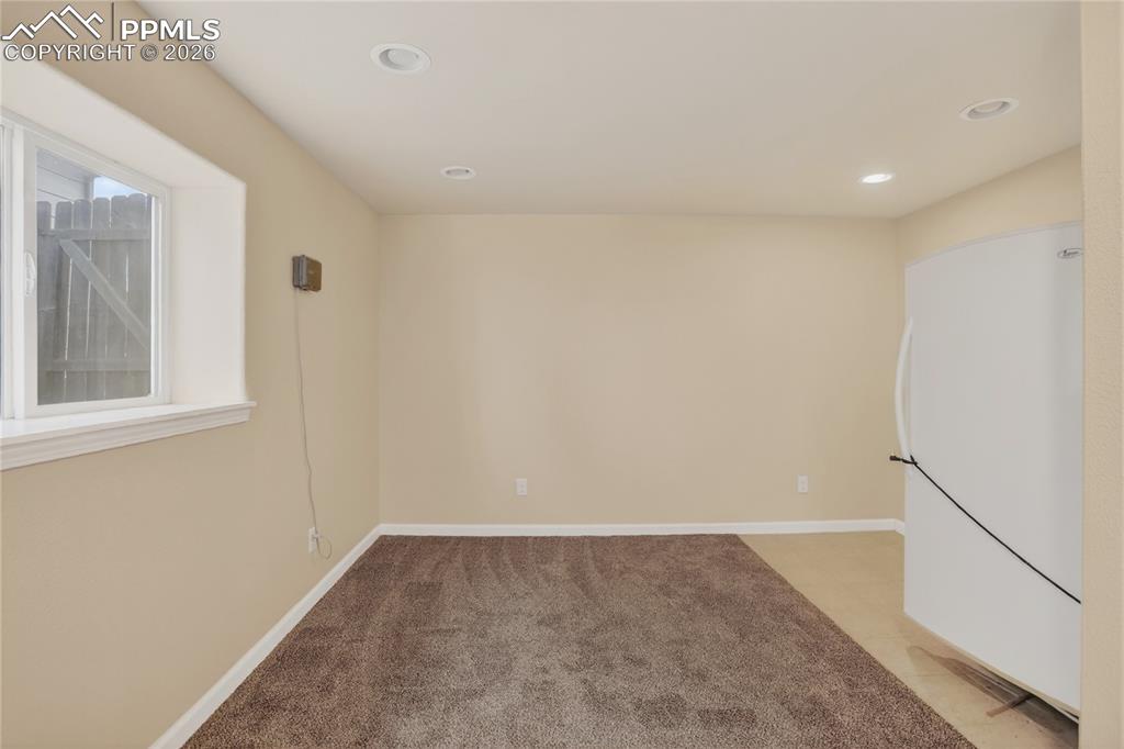 Image 19 of 24: Rec room w/ freezer