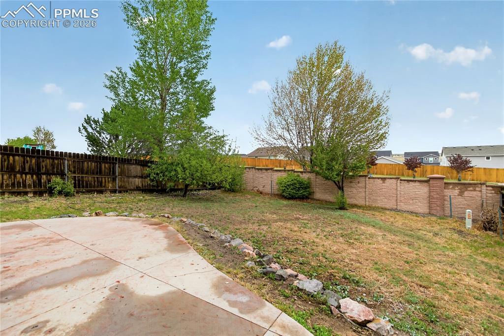 Image 23 of 24: Spacious yard w/ patio