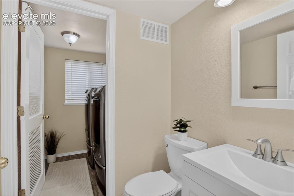 Image 9 of 24: Powder room & laundry - main level