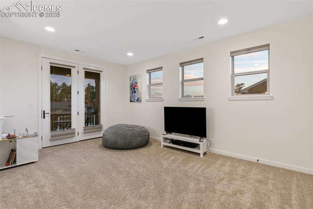 Image 24 of 50: Upper level walk out to balcony