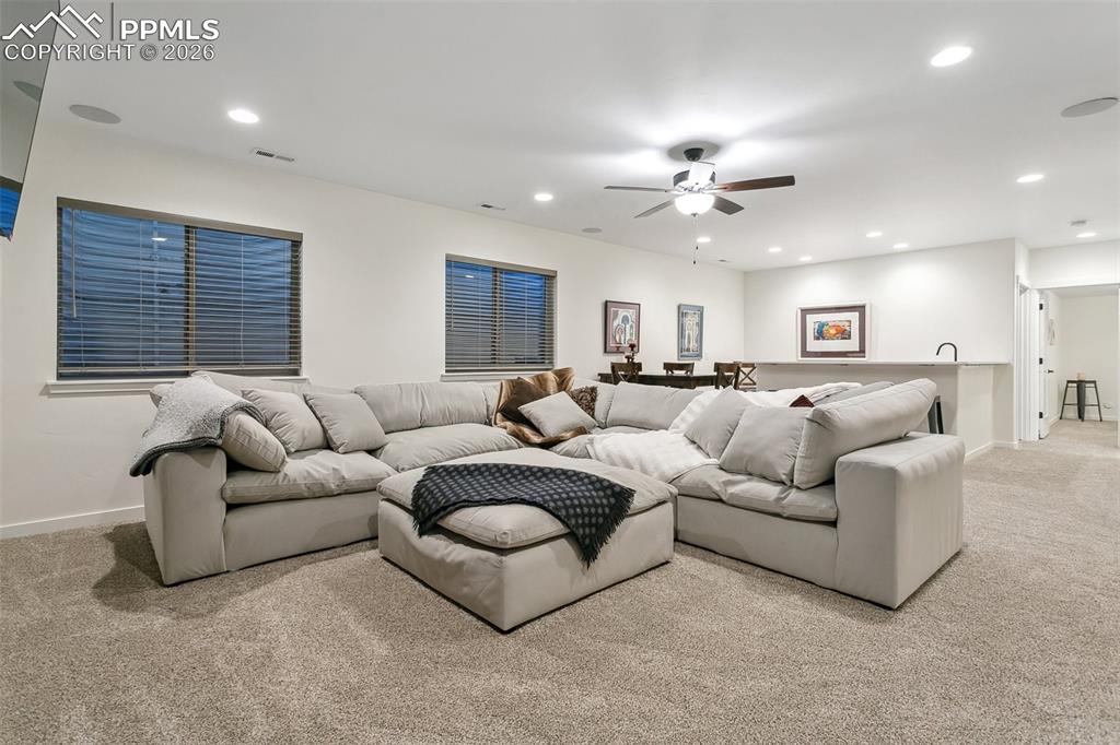 Image 36 of 50: Basement family room with wet bar and fireplace