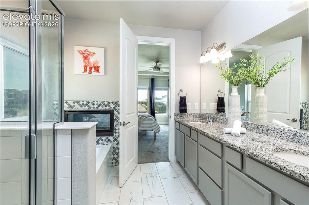 Image 22 of 43: Dual vanity with integrated sinks and a speckled countertop
