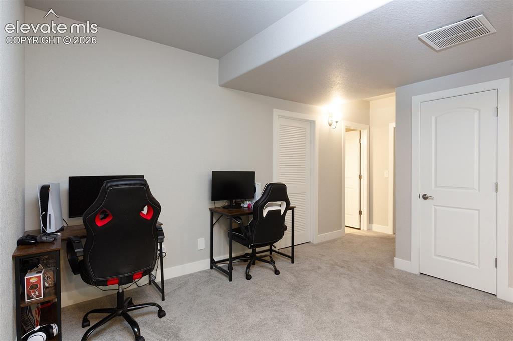 Image 26 of 43: Light gray walls, light gray carpeting, and white trim