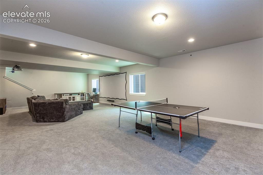 Image 27 of 43: Spacious lower level featuring carpeted flooring, recessed lighting, built-