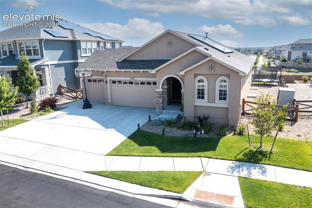 Image 3 of 43: Stucco exterior with stone accents and arched entry