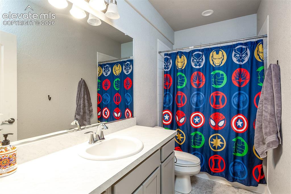 Image 31 of 43: Single vanity with integrated sink, chrome faucet, and expansive wall mirro