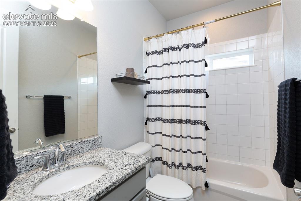 Image 7 of 43: Front Bathroom - Vanity with granite-style countertop, single basin sink, a
