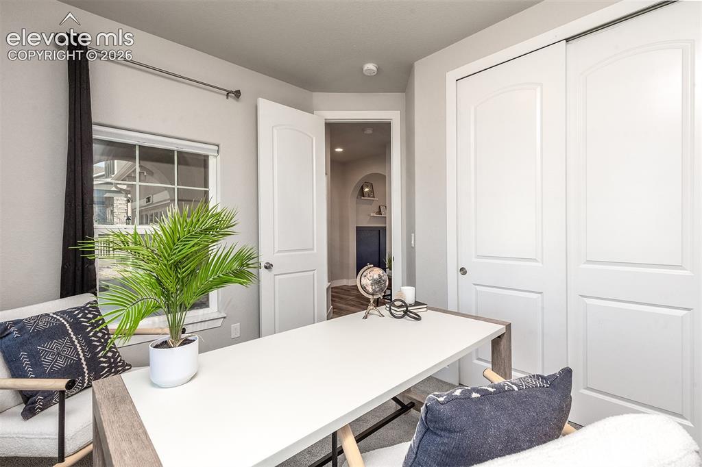 Image 8 of 43: Main level bedroom. Currently staged as an office.