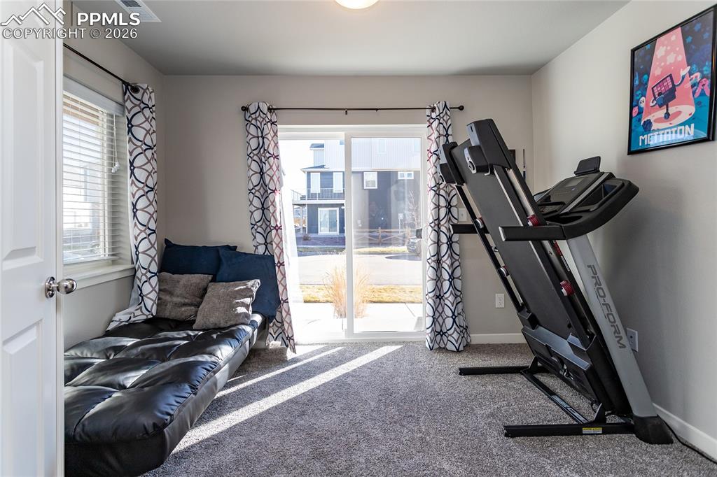 Image 8 of 34: Main level bonus room with French doors