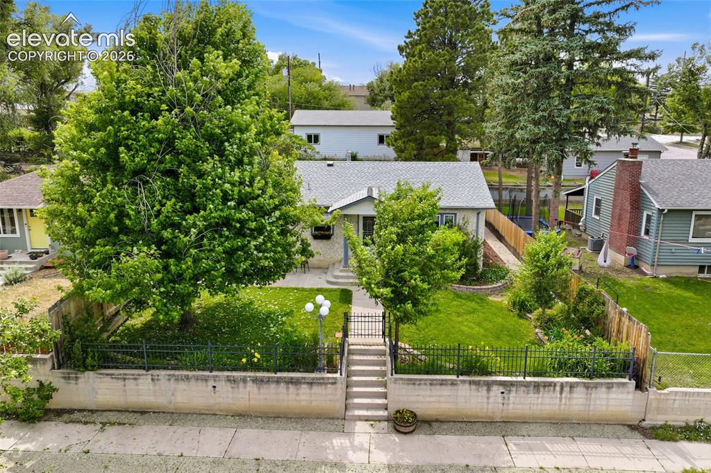 Image 40 of 50: Single-story residential property with a light-colored exterior and a gray