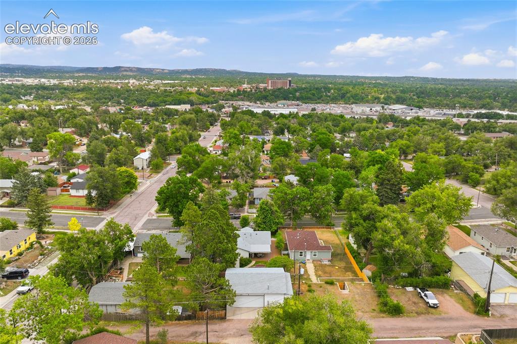 Image 45 of 50: Aerial view of the property featuring a main residence with a light gray sh