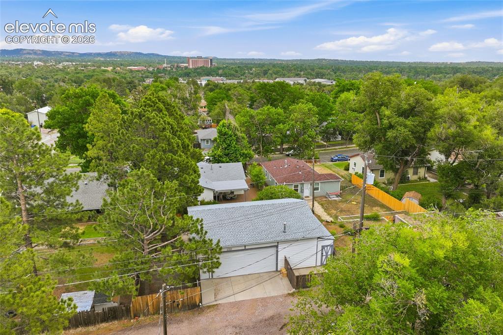 Image 46 of 50: Aerial perspective showcasing residential properties with established trees
