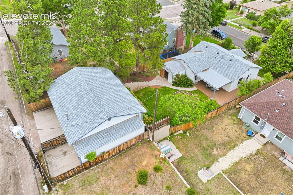 Image 47 of 50: Two-car detached garage with a gabled roof, driveway access, and a wood pri
