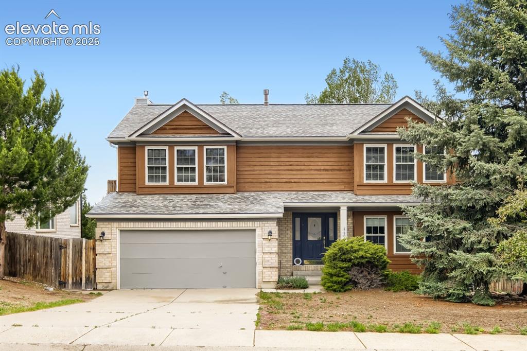 Image 1 of 28: Two-story residence featuring a two-car garage with light gray door