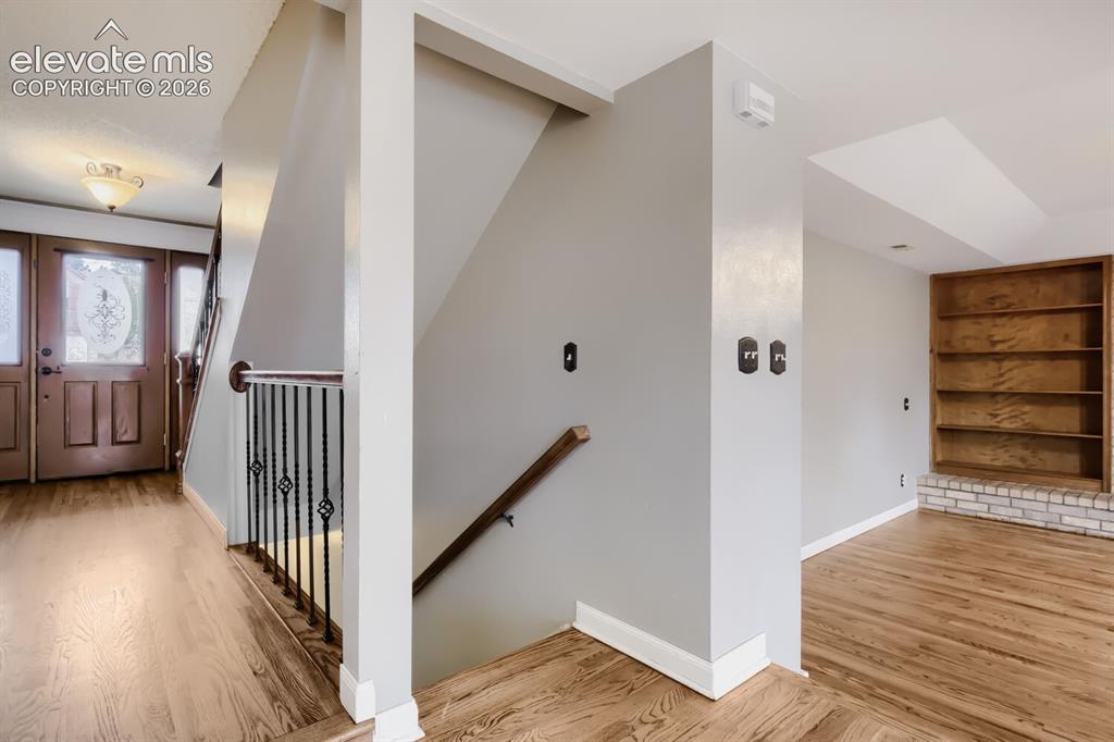 Image 17 of 28: Entryway featuring wood-finish flooring, a decorative glass front door, and