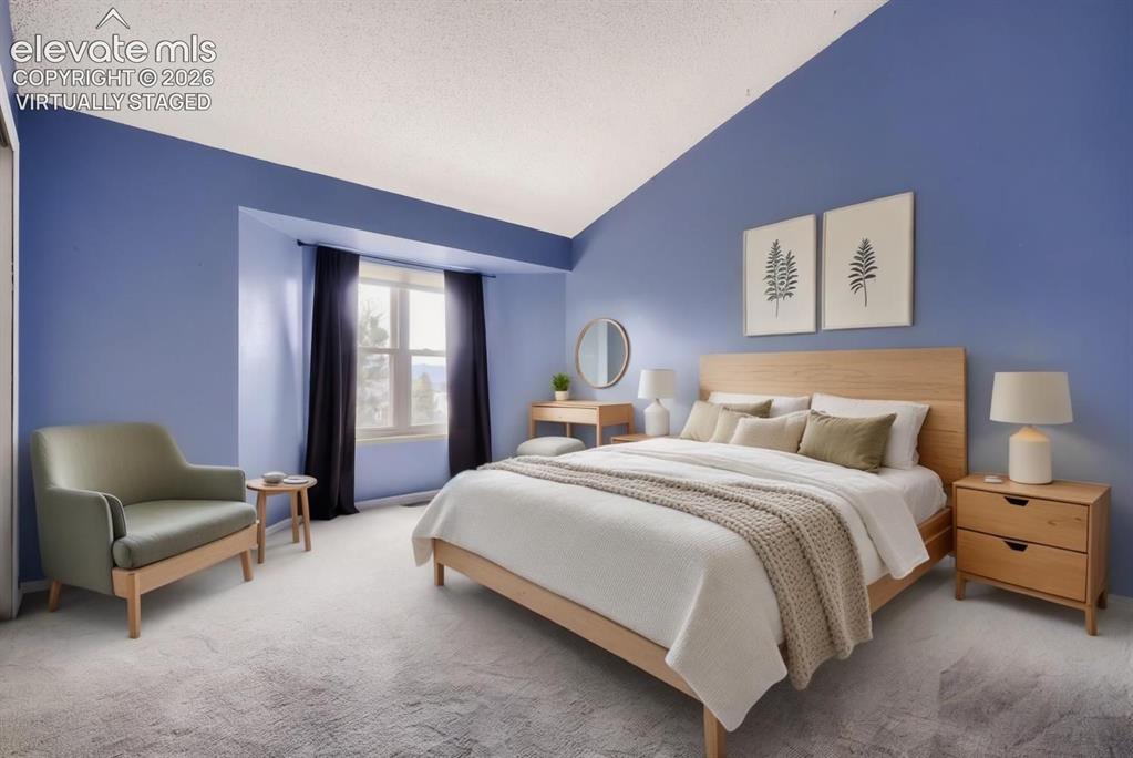 Image 8 of 28: Spacious room featuring a vaulted ceiling, recessed window, and light-toned