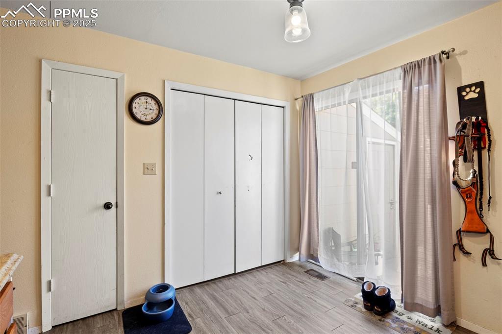 Image 15 of 31: Unfurnished bedroom with wood finished floors and a closet