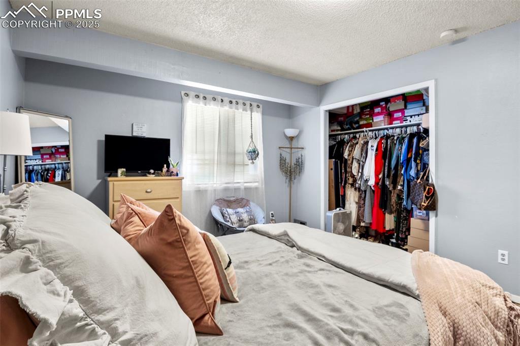 Image 18 of 31: Bedroom with a closet and a textured ceiling