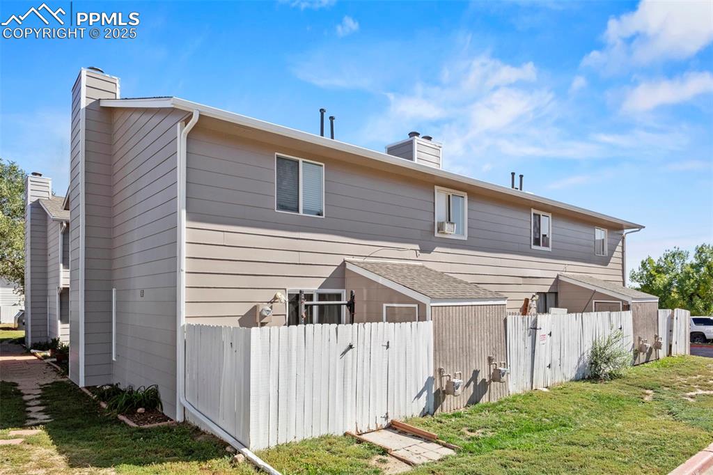 Image 29 of 31: Back of property featuring a chimney and a gate