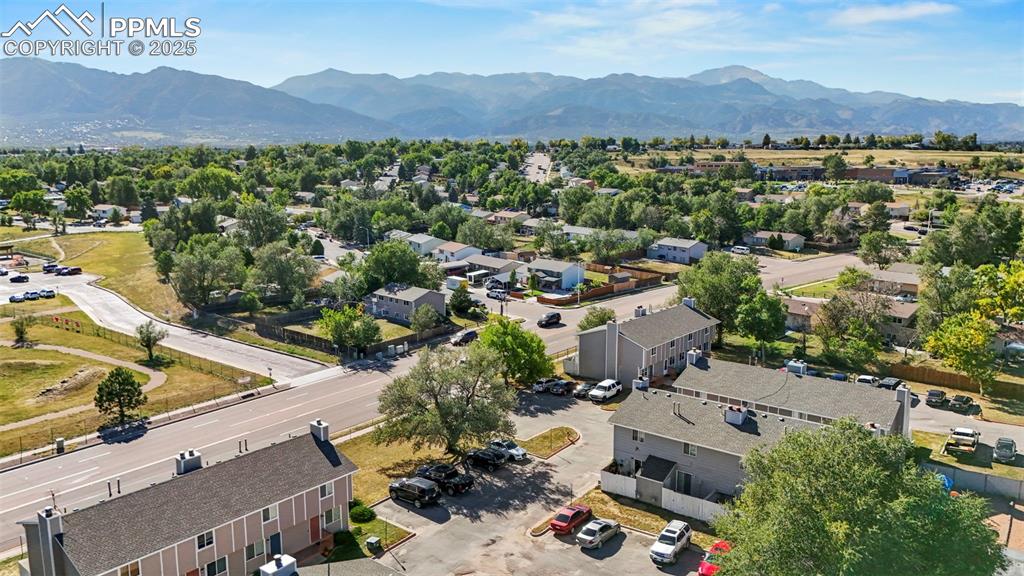 Image 30 of 31: Aerial view of residential area with a mountain backdrop