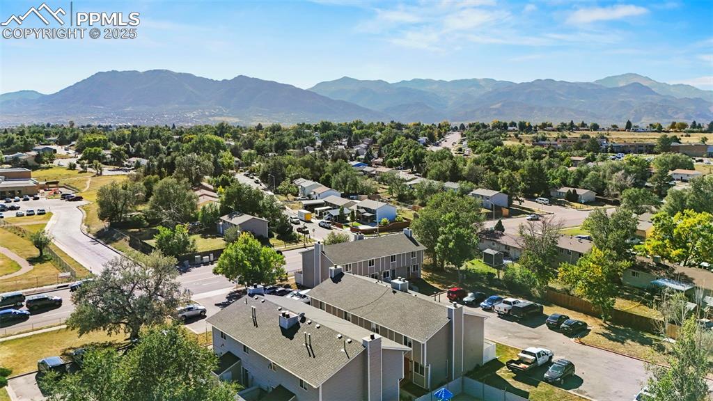 Image 31 of 31: Aerial view of residential area with a mountainous background