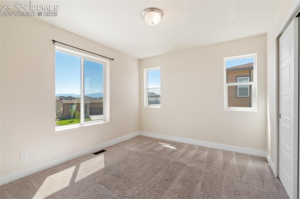Image 16 of 35: Carpeted empty room with baseboards