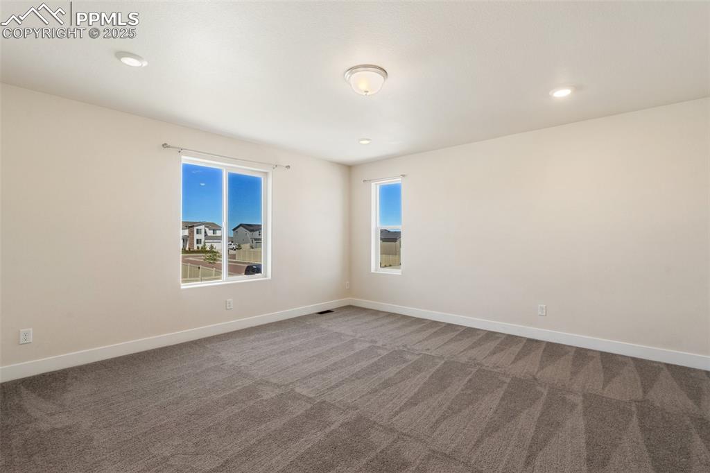 Image 19 of 35: Carpeted empty room with baseboards and recessed lighting