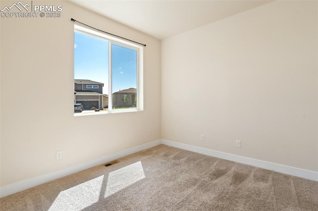 Image 2 of 35: Unfurnished room featuring carpet and baseboards