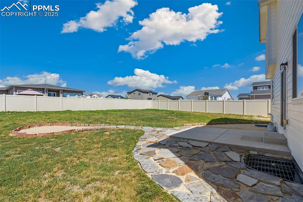 Image 23 of 35: View of yard with a patio and a residential view
