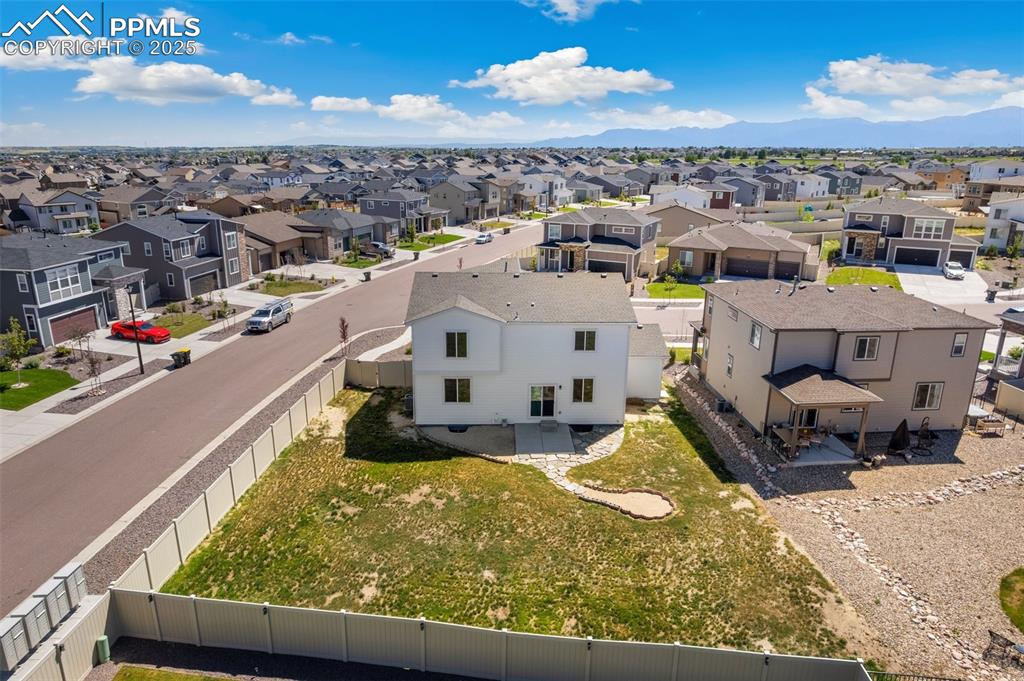 Image 30 of 35: Aerial perspective of suburban area with a mountainous background
