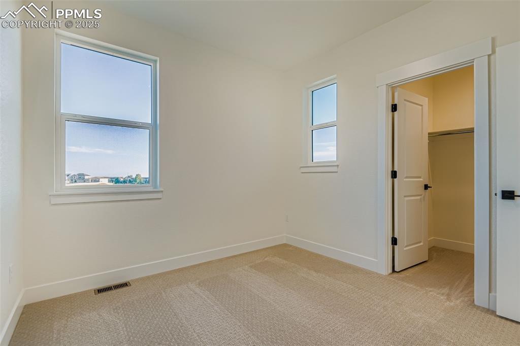 Image 20 of 28: Spare room with light carpet