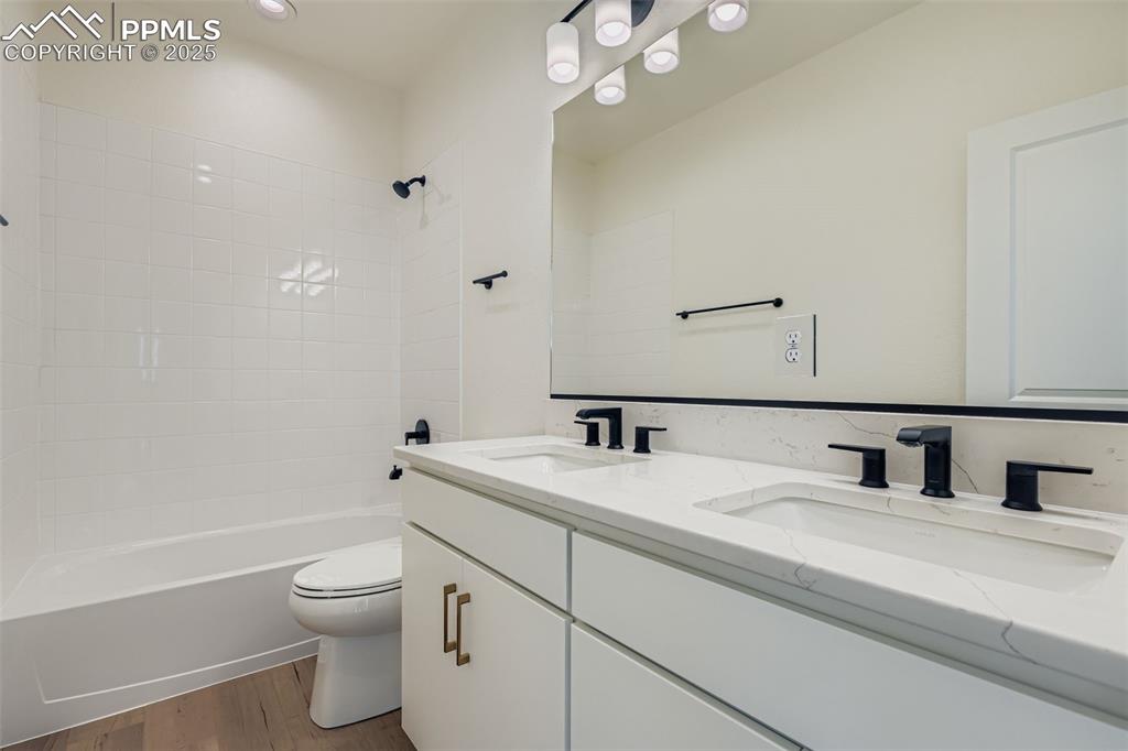 Image 22 of 28: Bathroom with shower / bathtub combination, dark wood finished floors, and 