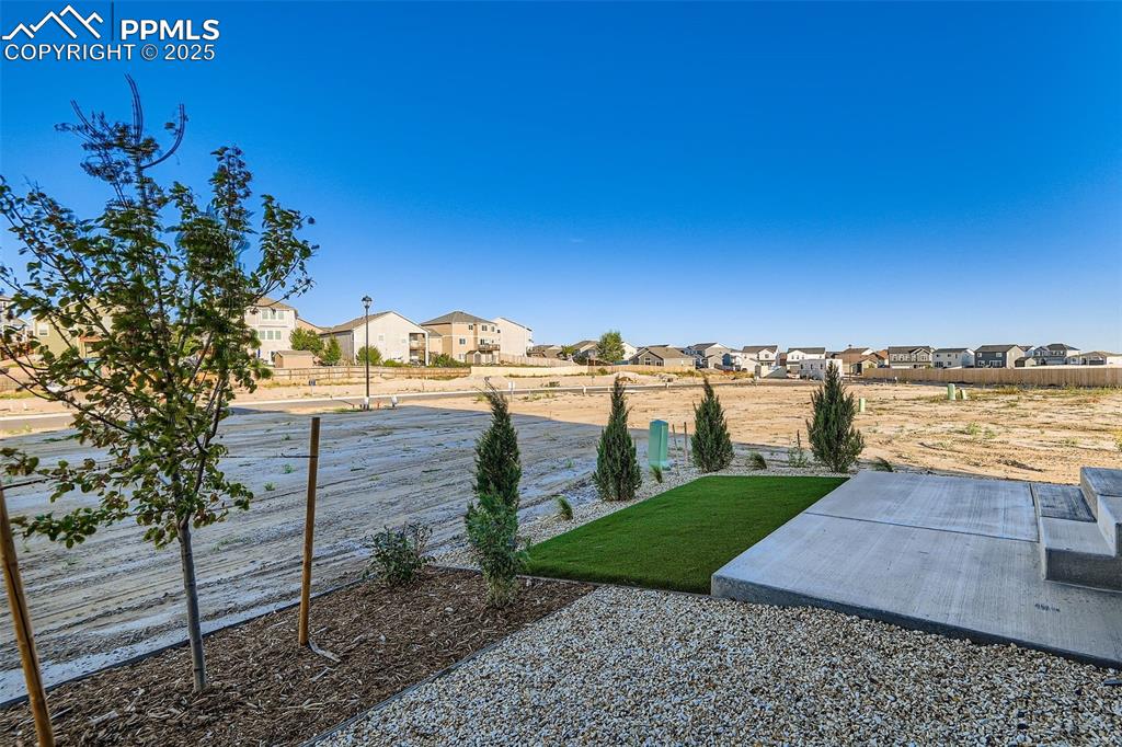 Image 27 of 28: View of yard featuring a residential view and a patio