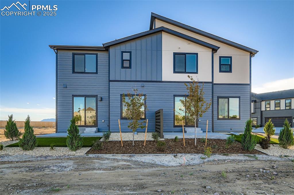 Image 28 of 28: Back of house with board and batten siding