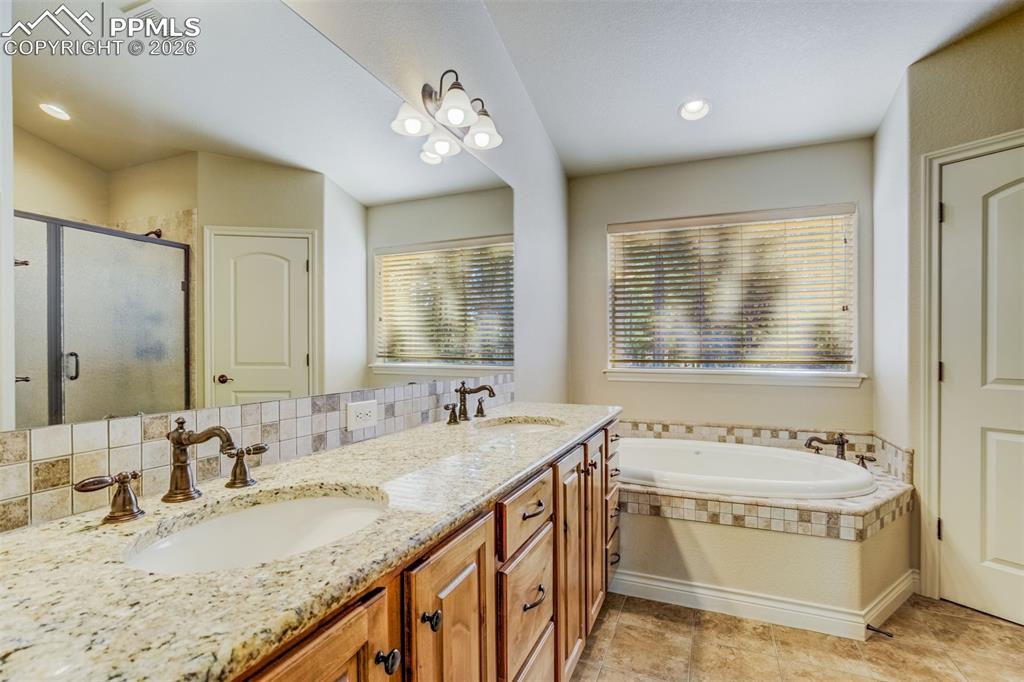 Image 16 of 38: 5 pc master bath with double vanity, soaking tub, shower w/seat, water clos