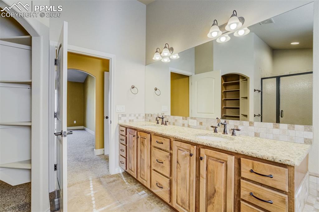 Image 18 of 38: 5 pc master bath with double vanity, soaking tub, shower w/seat, water clos